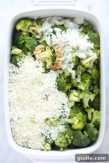 A white baking dish filled with broccoli and rice.