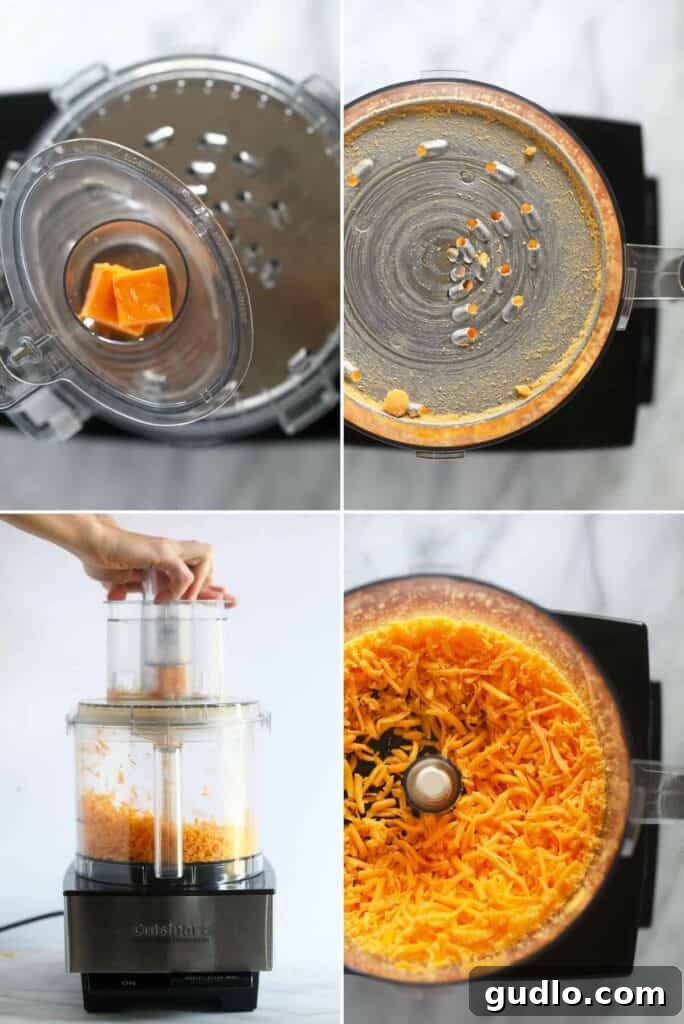 A block of cheddar cheese being placed into a food processor with a shredding attachment.