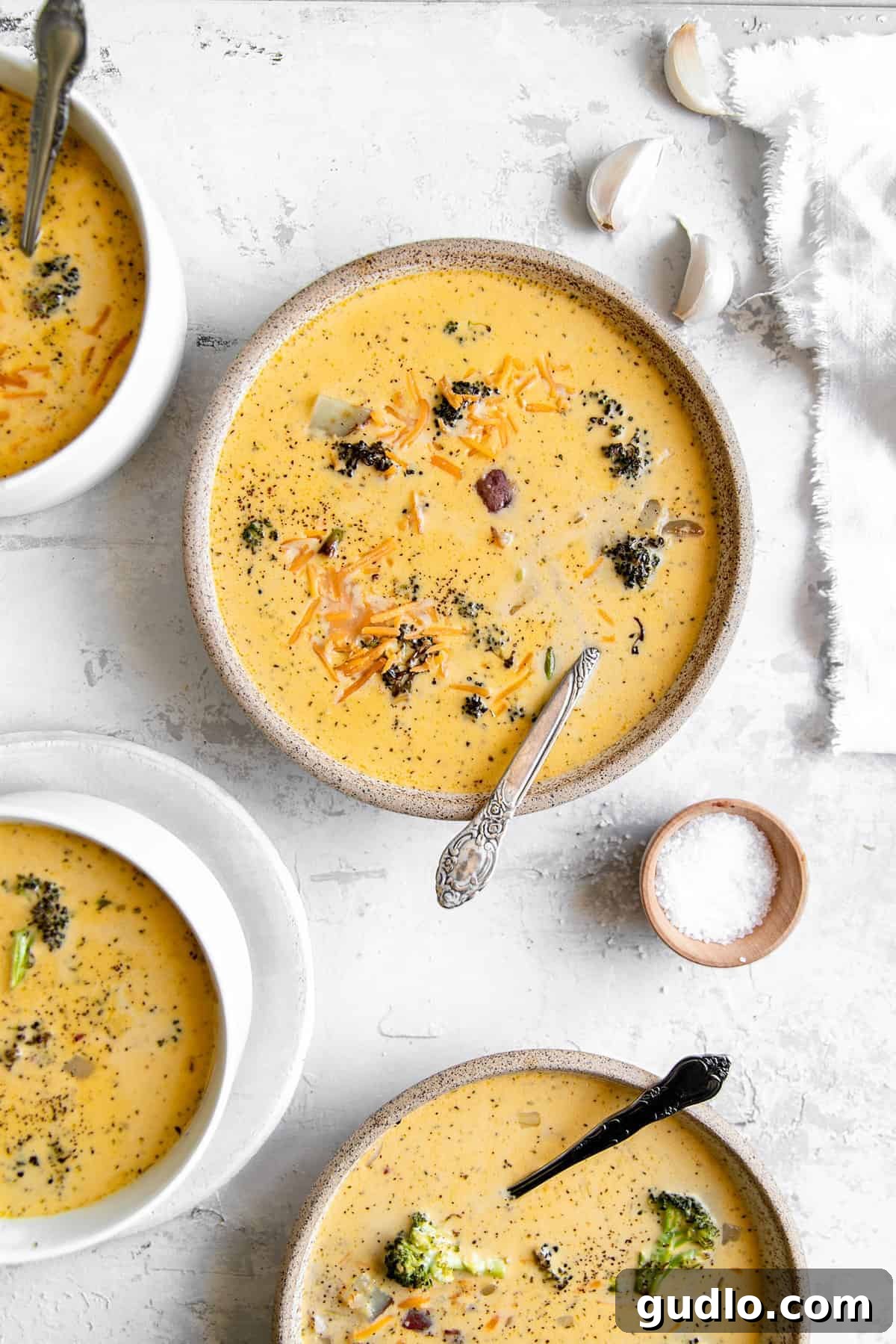 Velvety Broccoli & Cheddar 2 A steaming bowl of creamy roasted broccoli cheddar soup, garnished with fresh herbs, inviting and comforting.