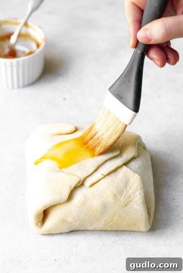 whipping egg wash on puff pastry.