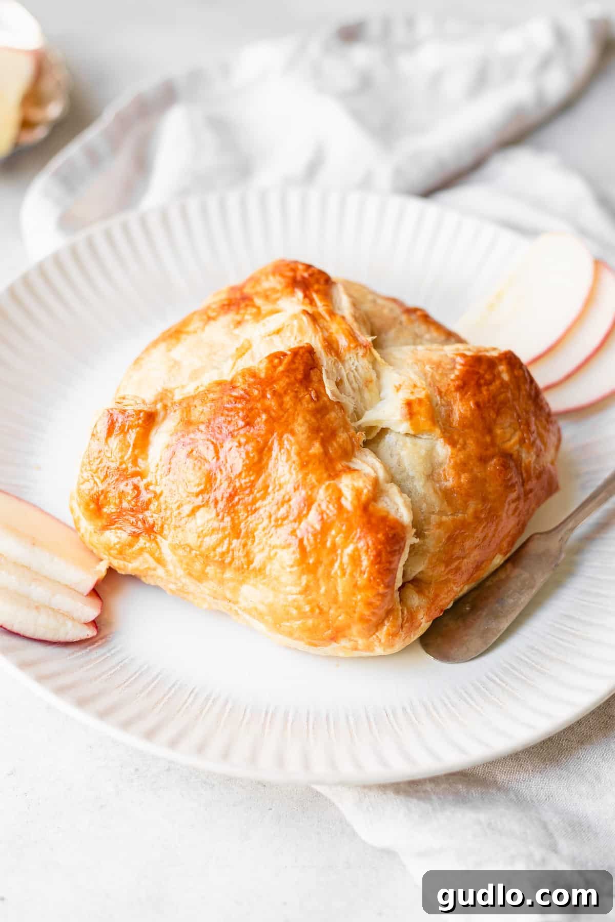 baked brie on a serving plate, ready to be enjoyed.