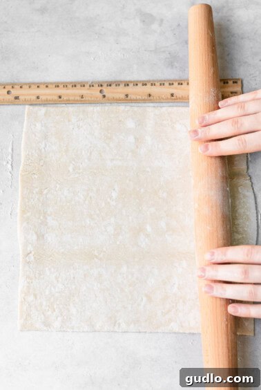 rolling out puff pastry.