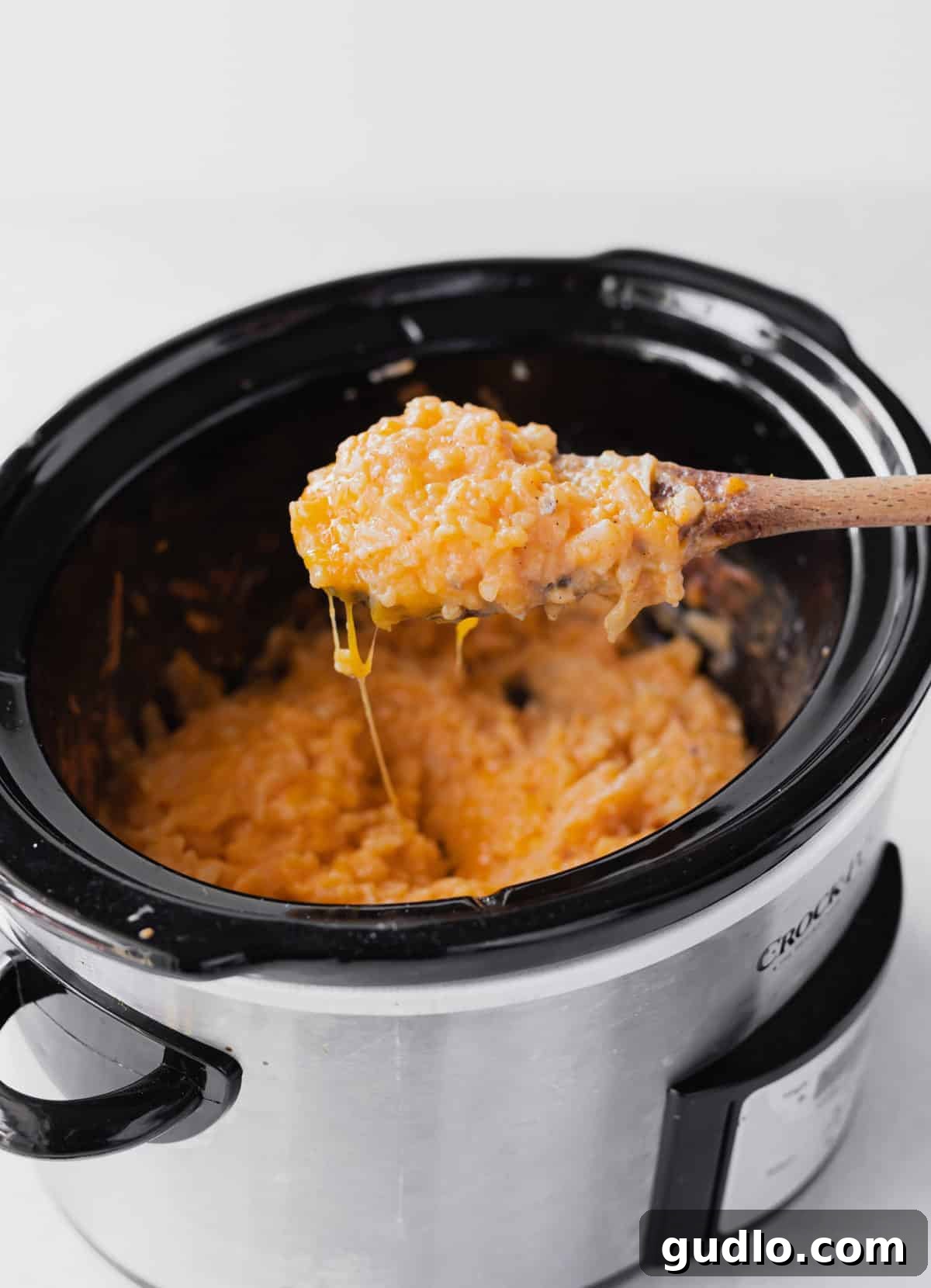Make these crockpot cheesy potatoes with real potatoes in no time using your slow cooker and just 5 main ingredients! A generous serving of rich, golden cheesy potatoes in a crock pot, ready to be served.