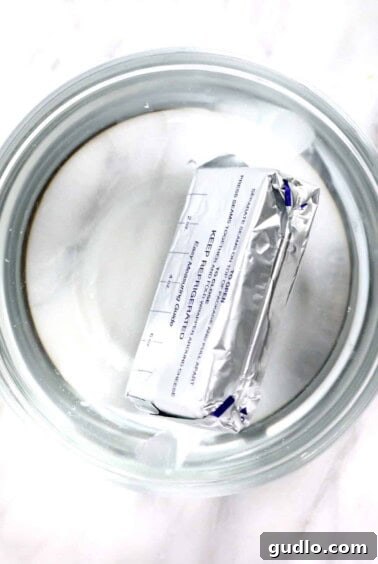 Wrapped cream cheese in warm water, keeping it safe from moisture.