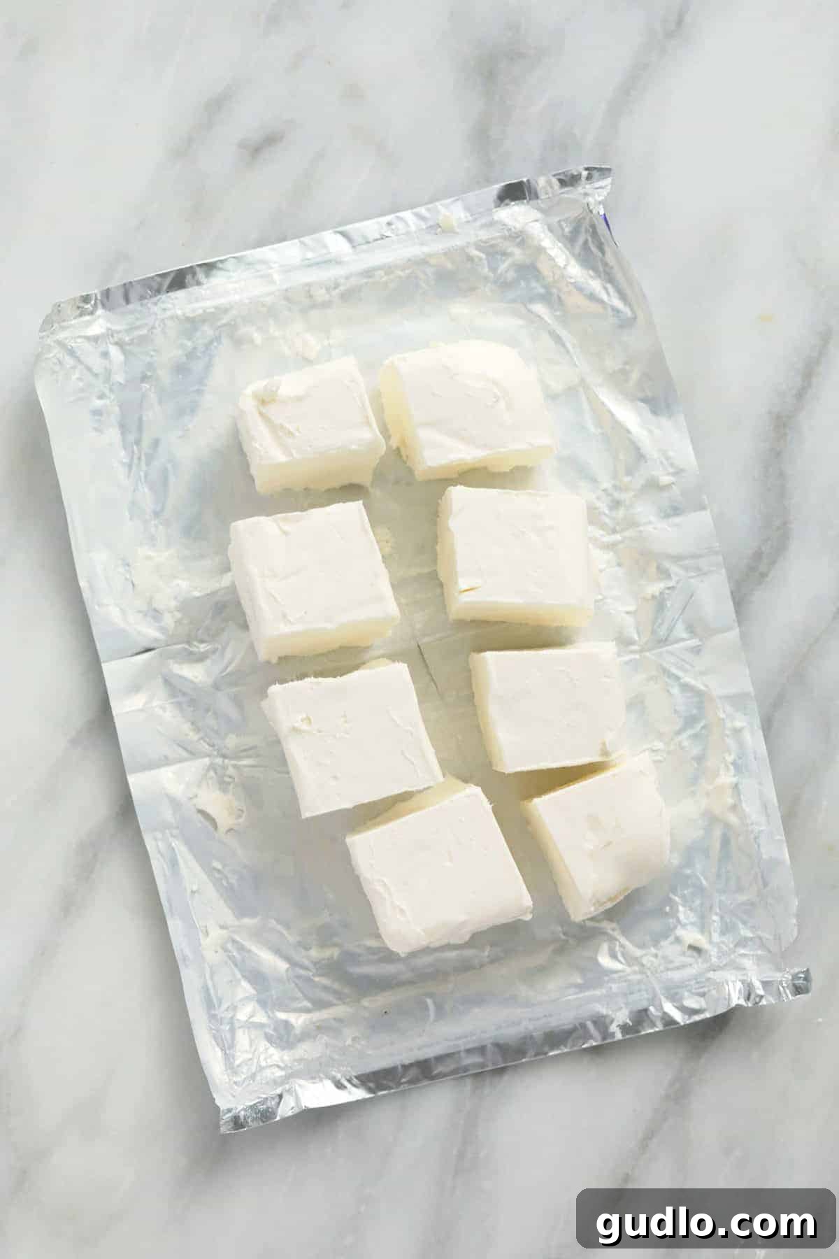 Cubed cream cheese on a plate, method to soften faster.