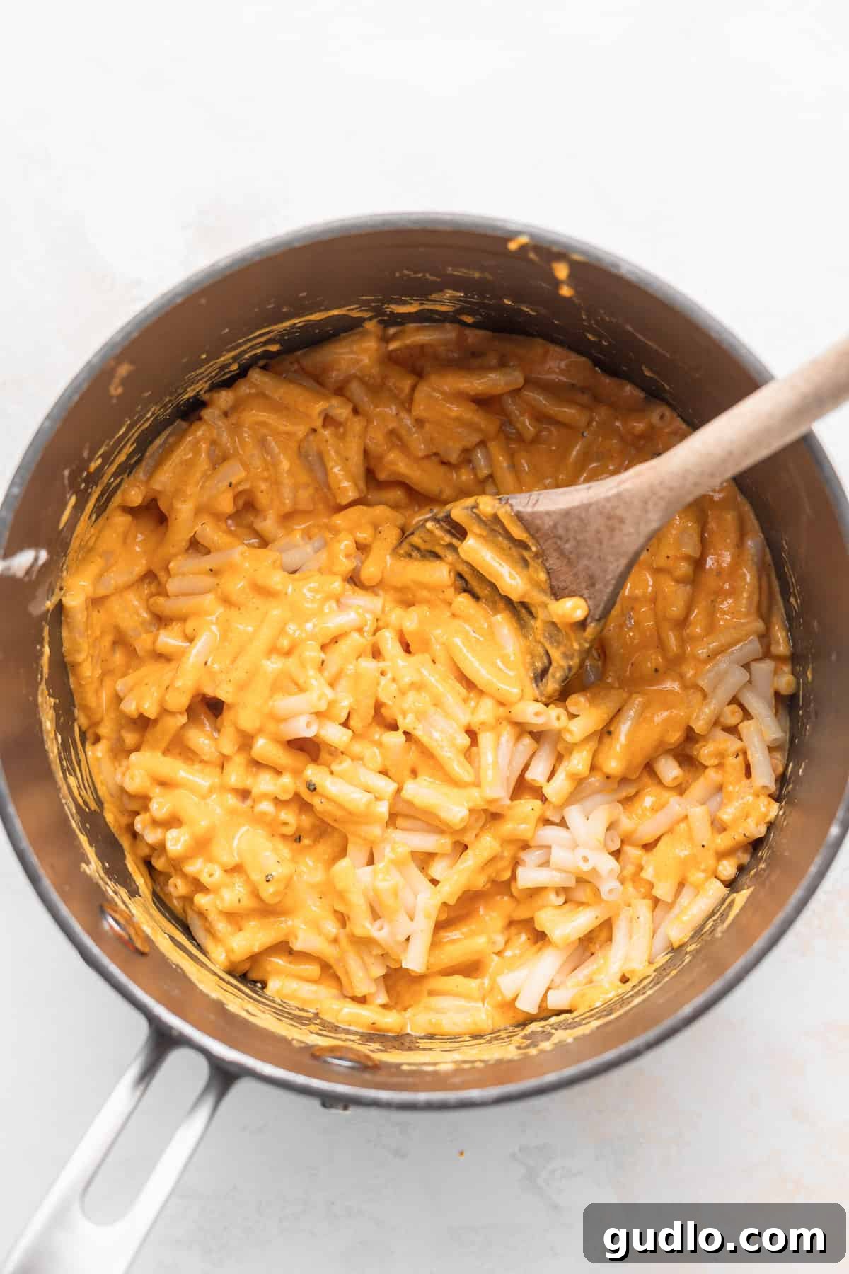 Next-Level Boxed Mac and Cheese Hacks 5 Creamy mac and cheese with perfectly coated noodles in a saucepan.