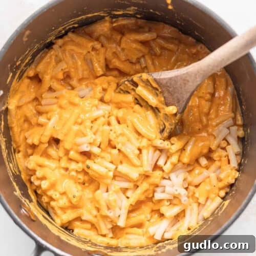 Next-Level Boxed Mac and Cheese Hacks 7 Boxed mac and cheese simmering in a pot.