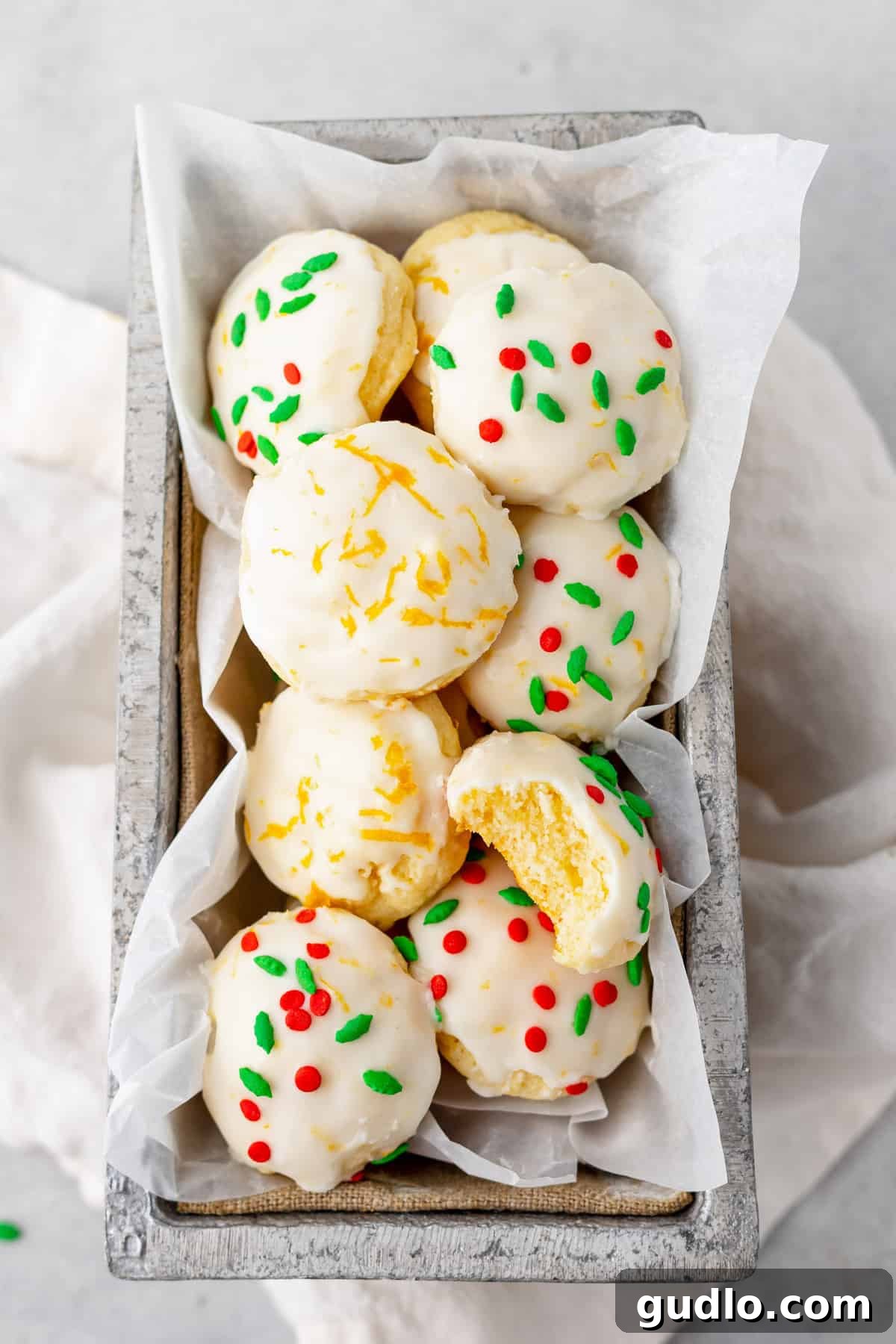 A rustic basket filled with an assortment of freshly baked ricotta cookies, ready to be enjoyed.