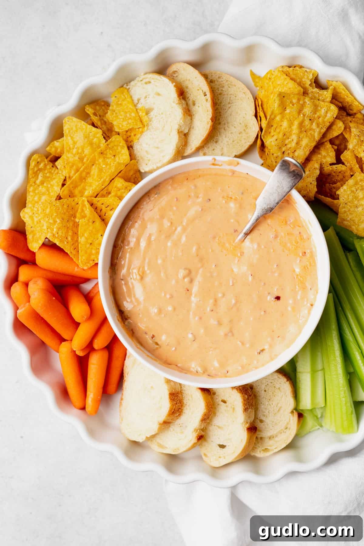 Slow Cooker Queso Dip in a Bowl A beautiful bowl of slow cooker queso dip, showcasing its golden color and inviting texture.