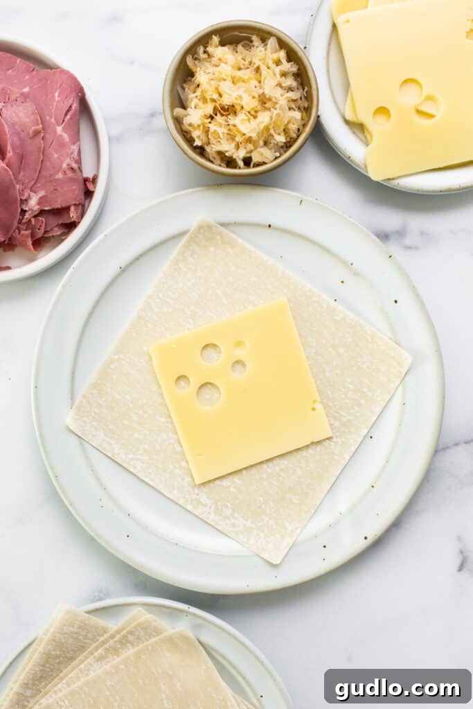 Freshly sliced Swiss cheese and deli corned beef ready for assembly.