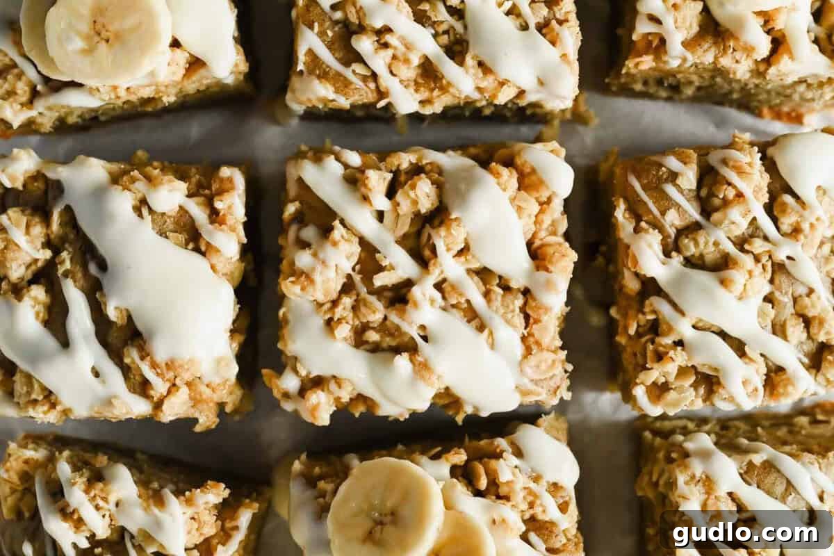 Morning Buzz Banana Cake 2 Slices of moist banana coffee cake with a buttery streusel topping and cream cheese glaze on parchment paper.