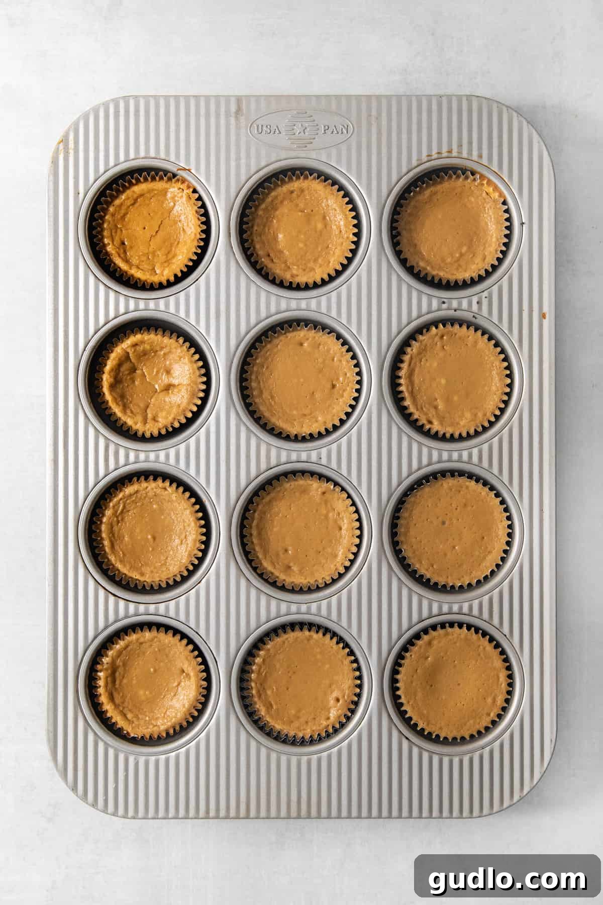 Mini Espresso Cheesecake Cups: No-Bake Coffee Dessert 3 Twelve espresso cheesecake cups filled with coffee cheesecake batter in a muffin tin.