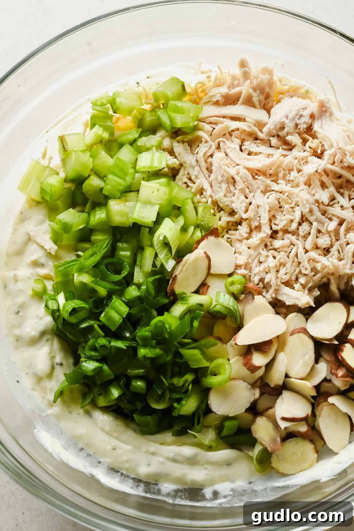 Cooked chicken, diced celery, green onions, and sliced almonds added to creamy Boursin dressing.