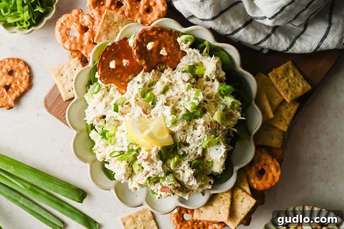 Finished Boursin chicken salad spread served with crunchy crackers and pretzels.