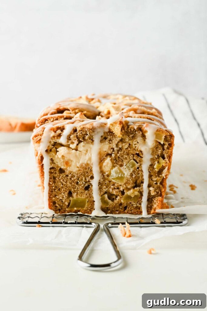 Apple Fritter Bread with Cream Cheese Swirl 2 Apple fritter bread cross-section with diced apples, glaze, and cream cheese filling
