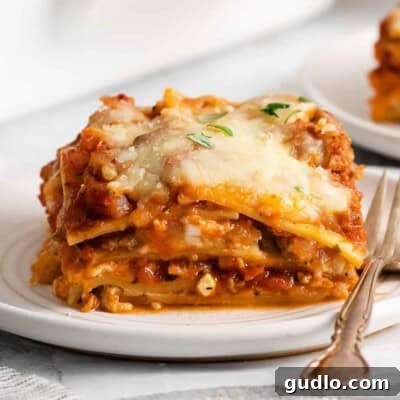 Lasagna on a plate with a fork.